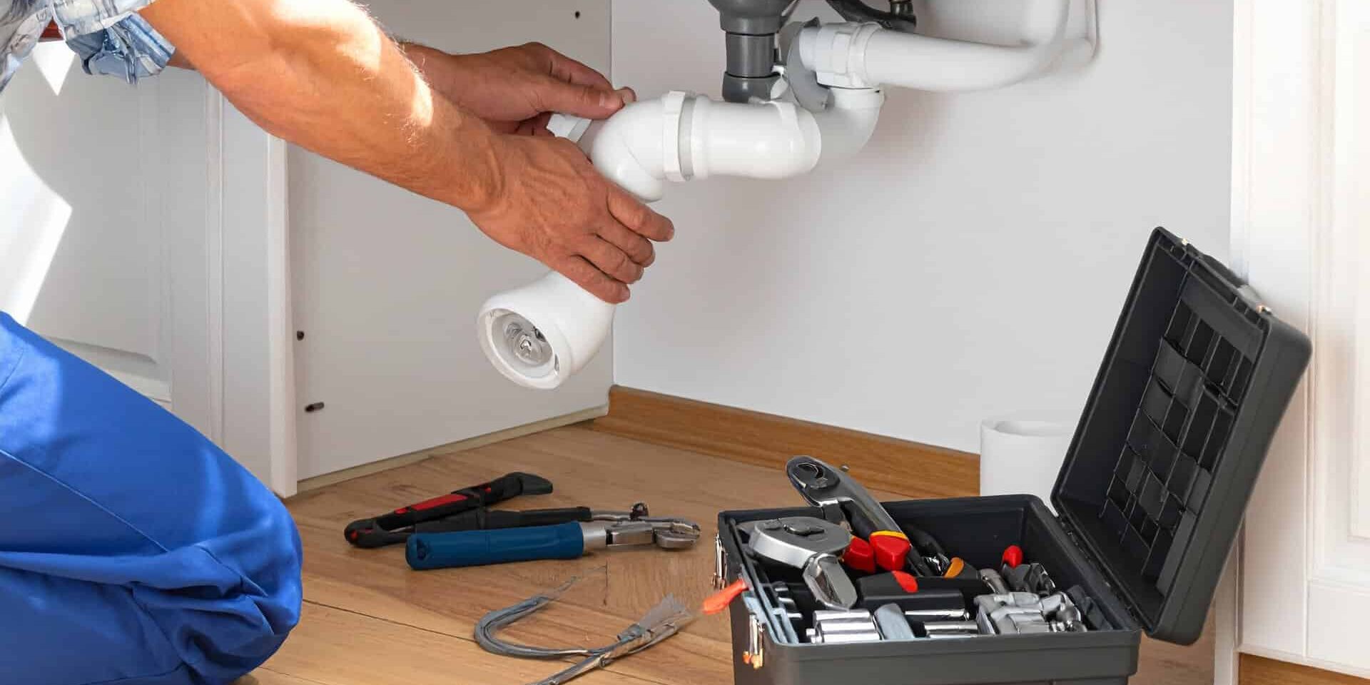 Plumber-Fixing-Under-Sink-Drain-With-Tools